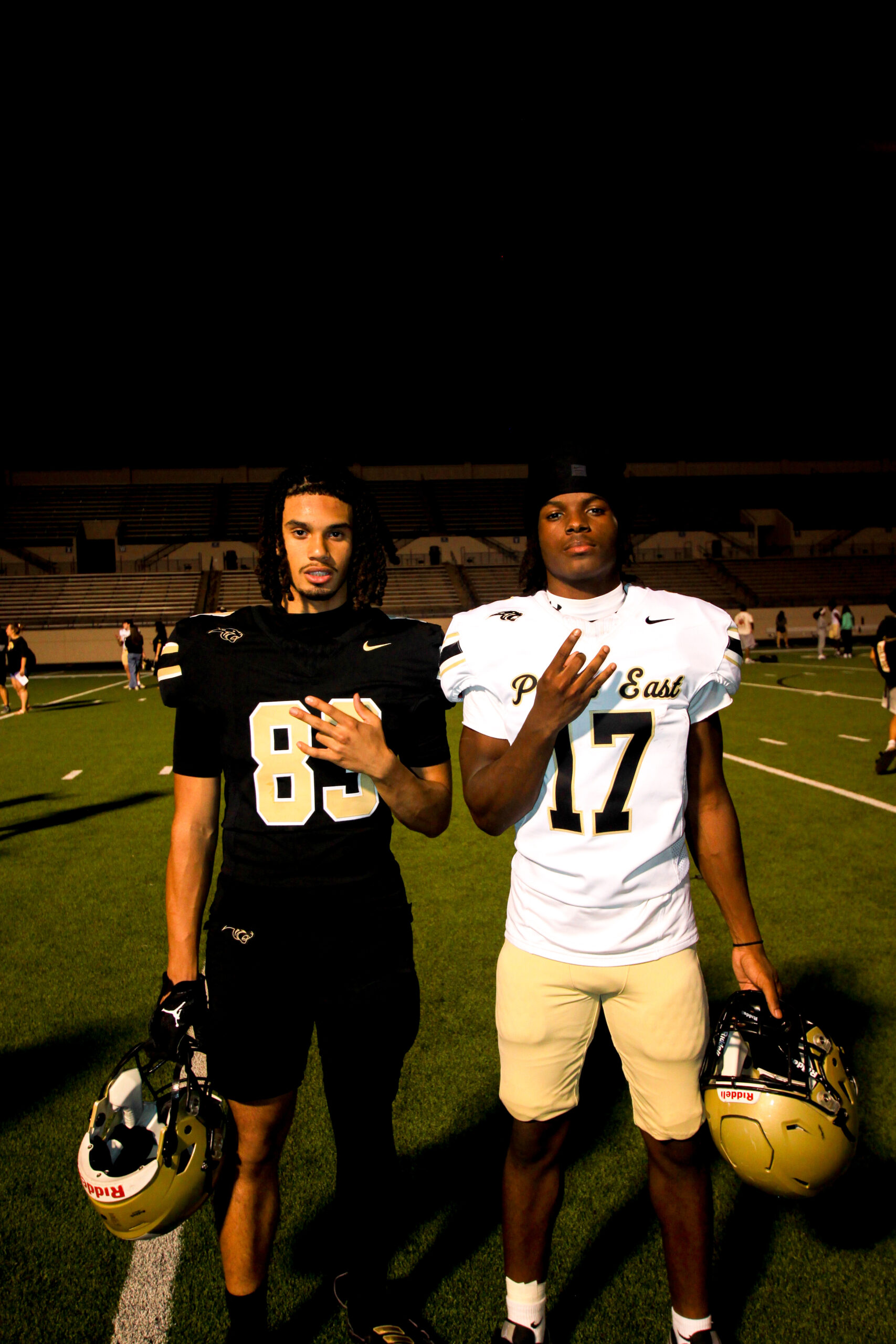 Leon encouraging a linebacker during a high school football game